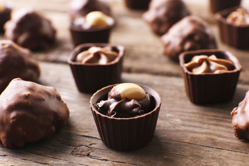 Chocolate sweets on wooden background
