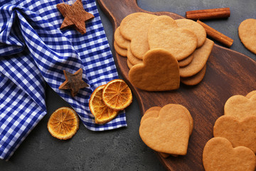Fototapeta na wymiar Heart shaped biscuits on cutting board, closeup