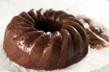 Chocolate cake on paper, closeup