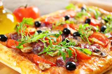 Rectangle delicious pizza and vegetables on the table, close-up