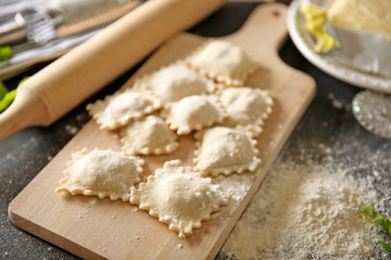 Uncooked ravioli on cutting board
