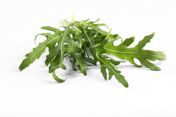 Fresh arugula leaves on white background