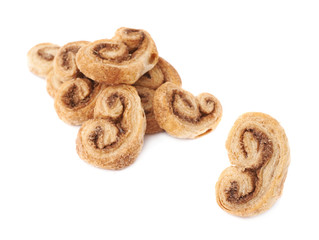 Single cookie next to Pile of cookies isolated over the white background