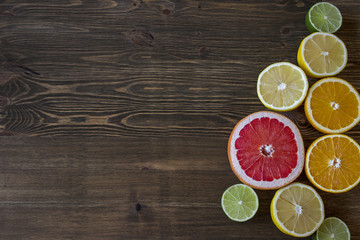 Citrus fruits. Over wood table background