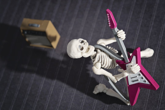 A Skeleton playing rock electric guitar
