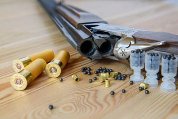 hunting rifle and ammunition, cartridges, on a wooden table.  