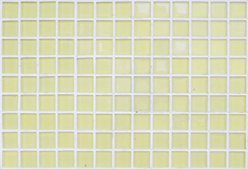 Closeup surface of yellow glass tile at the temple wall texture background