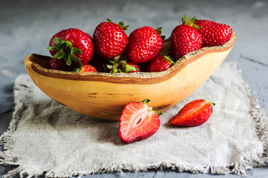 Fresh strawberries in a wooden bowl