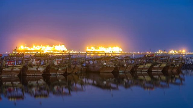 Fishing boat parked near the fish market next to Kuwait City Area day to night timelapse