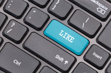 Computer keyboard closeup with "Like" text on blue enter key