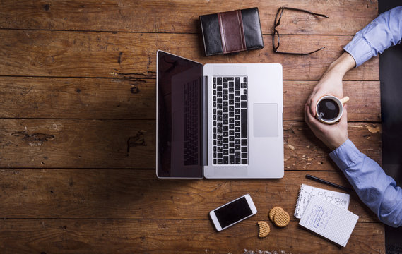 Man with coffee cup on desk