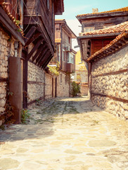 Street with historic architecture in the old town of Nessebar, landmarks of Bulgaria.