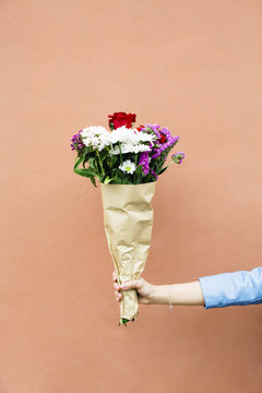 Woman holding bunch of flowers