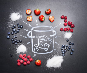 berry jam ingredients for a variety of berries, sugar and drawn with chalk on a chalkboard pan top view