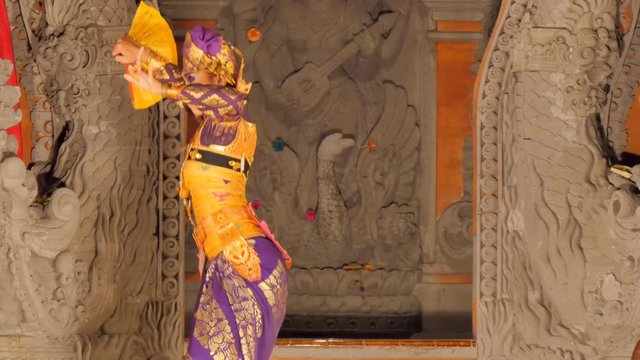 woman dancing on stage performing balinese traditional barong dance in costume model release signed