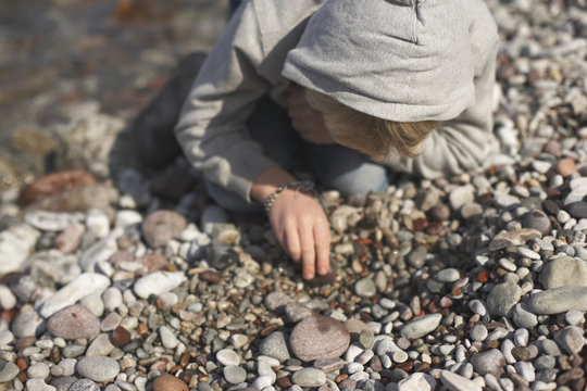 Boy looking at pebbles