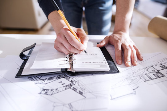 Architect making notes in his personal organiser