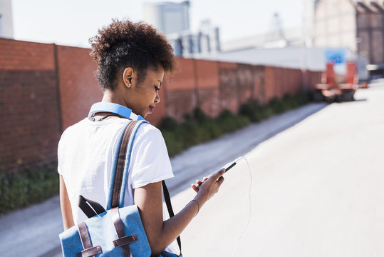 Young woman looking at cell phone outdoors