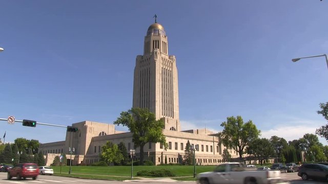 Nebraska Statehouse Capitol with traffic going by in Lincoln, Nebraska, USA.