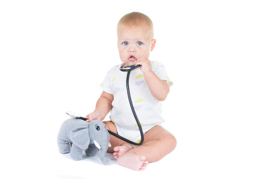 Adorable Child Dressed As Doctor Playing With Toy Isolated On White Background