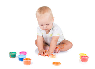 Cute little redhead girl painting with brush. Isolated on white background