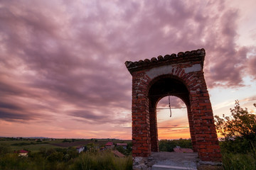 Fototapeta na wymiar old bell tower at sunset