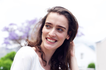 Smiling young woman looking to the side outdoors