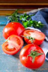 Fresh organic tomatoes on a wooden table, selective focus.