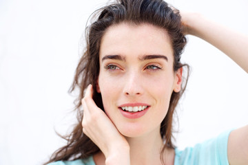 Fototapeta premium Beautiful smiling woman with hands in hair