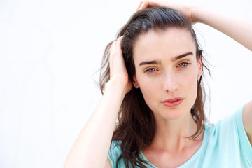 Obraz premium Young attractive woman with hands through hair