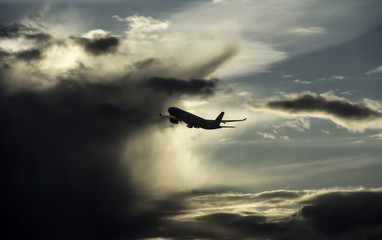 Fototapeta na wymiar outline of an airplane flying into thunderstorm cloud