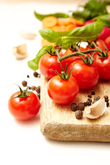Fresh organic ingredients on white background Tomatoe, garlic, pepper,carrots, radishes