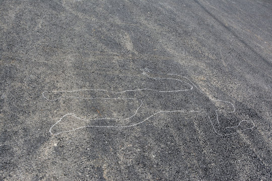 Chalk outline of body drawn on the road