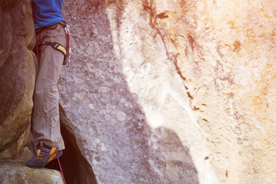 A rock climber climbs up the mountain.