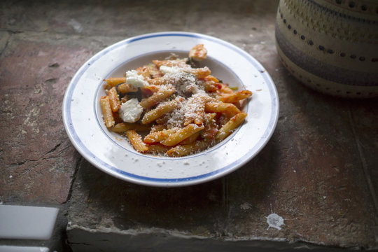 Plate with pasta with mozzarella and tomato