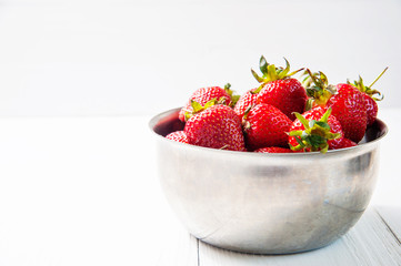Fresh strawberries on white wooden background