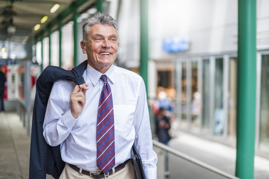 Smiling senior businessman in the city