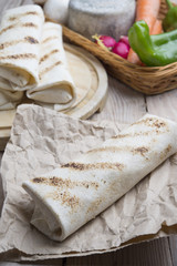 burrito on parchment with vegetables