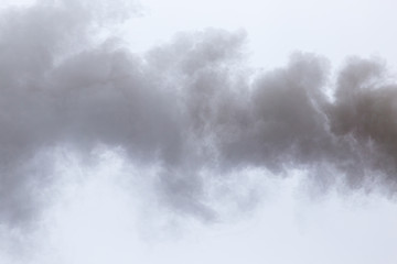 Smoke from a pipe on a cloudy sky