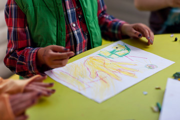 Fototapeta na wymiar Child draws pencil on paper hand
