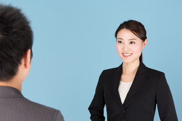 portrait of asian businesswoman isolated on blue background