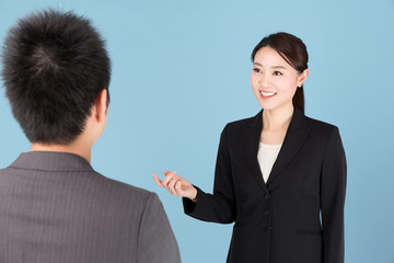 portrait of asian businesswoman isolated on blue background