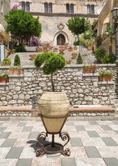 TAORMINA, ITALY - JULY, 2, 2015: Tourists walking near to the Clock Tower in Taormina, Sicily