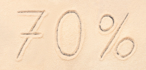 70 % lettering written on beach sand