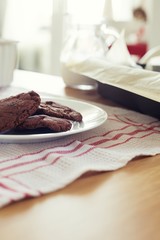 Fresh homemade cookies made with chocolate and brown sugar over the dining table after baked