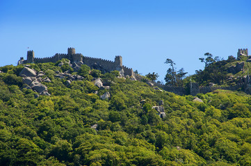Sintra is a resort town in the foothills of Portugals Sintra Mountains, near the capital of Lisbon. A longtime royal sanctuary, its forested terrain is studded with pastel-colored villas and palaces. 