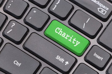 Computer keyboard closeup with "Charity" text on green enter key