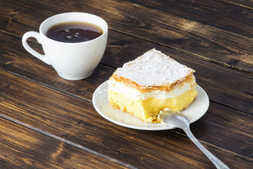 Tea and a peace of vanilla cream cake