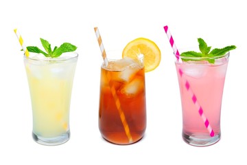 Three glasses of summer lemonade, iced tea, and pink lemonade drinks with straws isolated on a white background