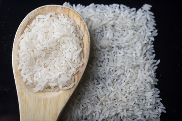 food background. brown rice in a wooden spoon. top view